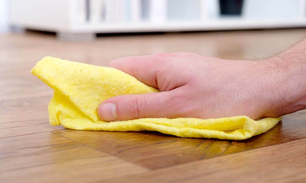 yellow cloth wiping mess up on floor 