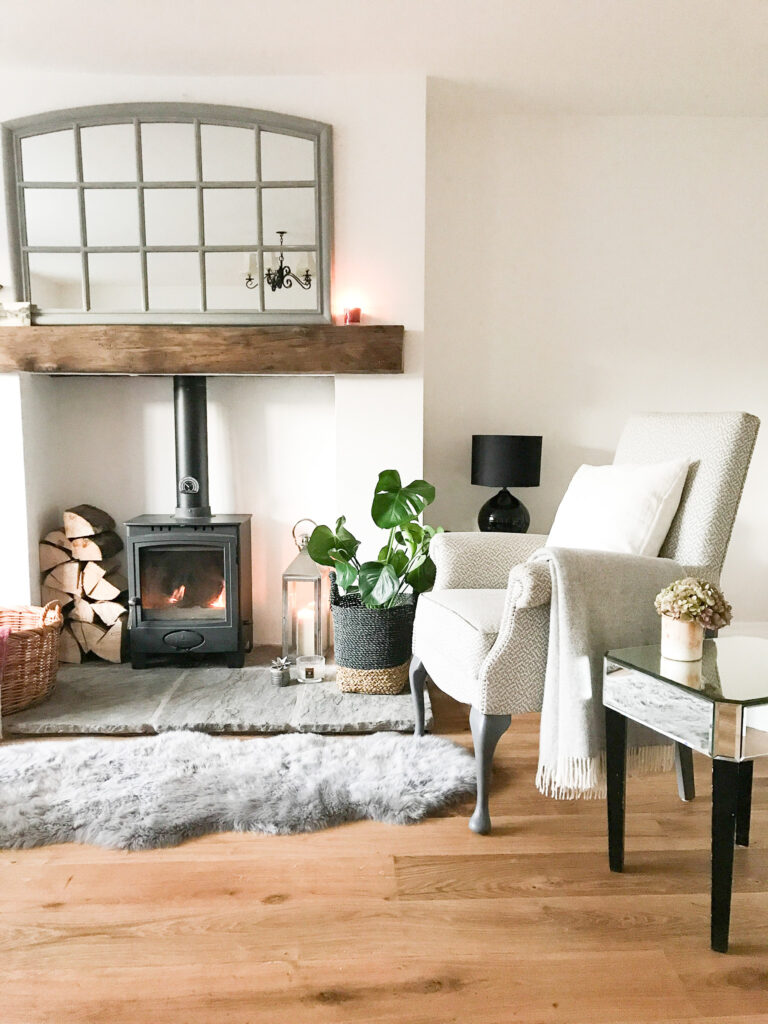 neautral coloured living room, white furnishings, fireplace and rug