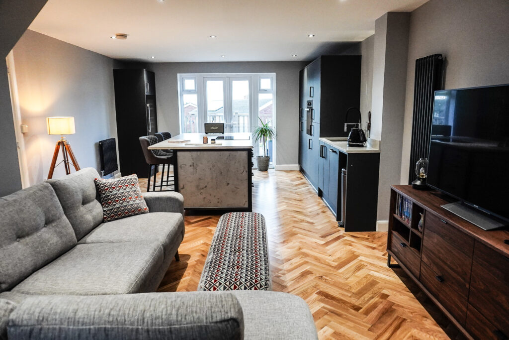 thorpe ranch oak in living room, grey sofas, floor lamps and open plan kitchen