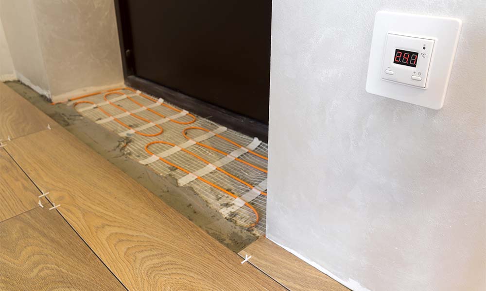 underfloor heating with wood flooring and thermostat