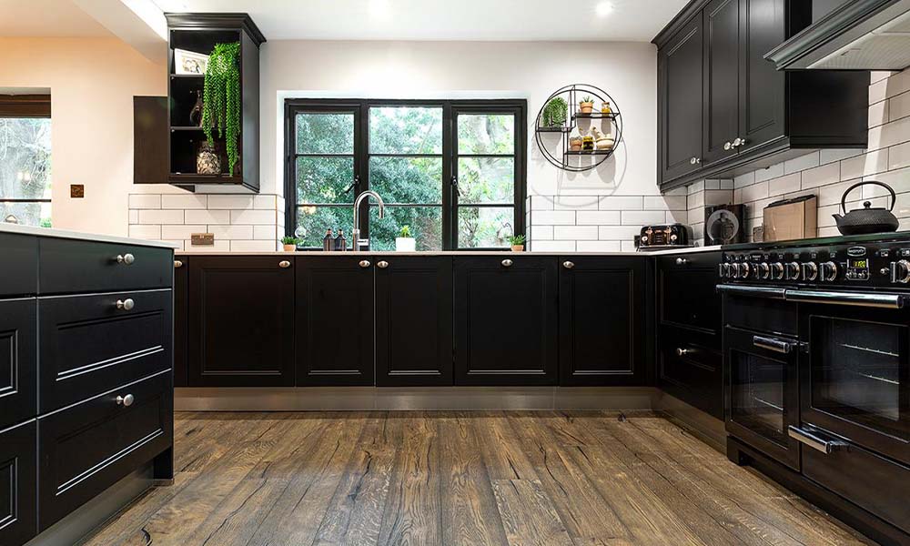 black and white themed kitchen with ditressed flooring 