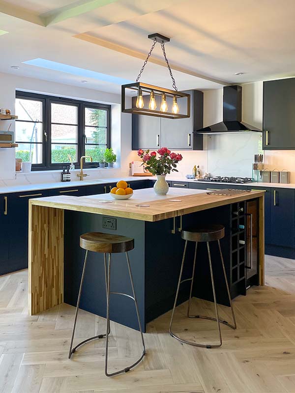 blue themed kitchen with light herringbone flooring