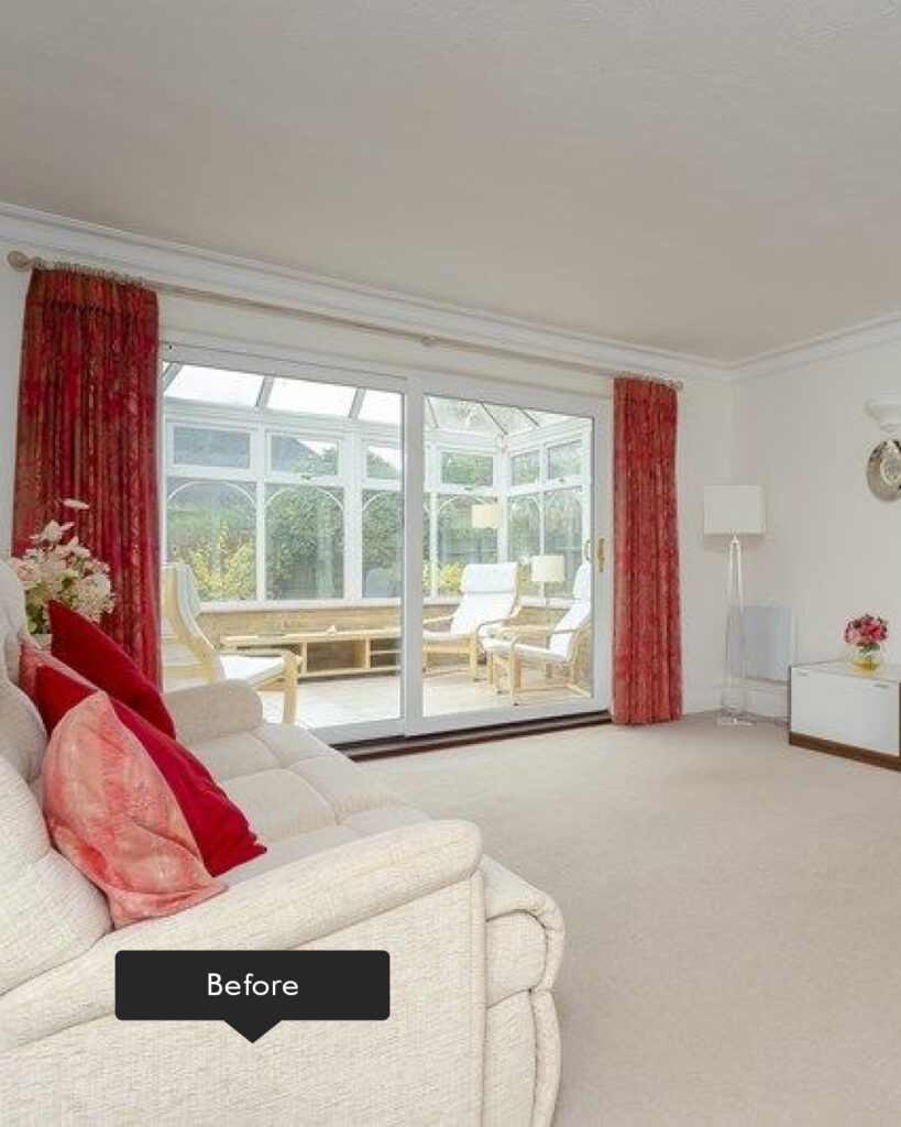 Living room with neural carpet, sofa and red curtains with adjoining conservatory