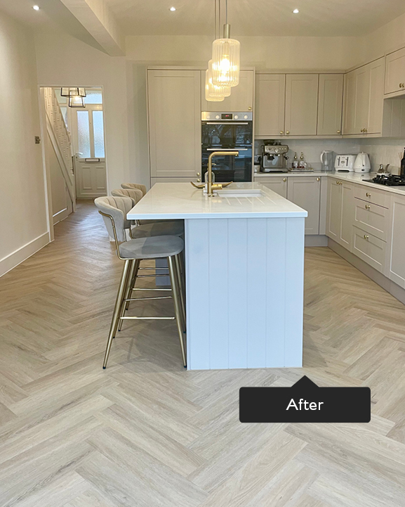 Neutral open plan kitchen with kitchen island and herringbone flooring