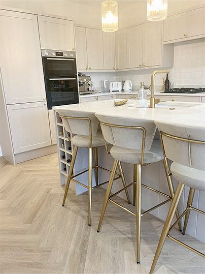Light grey and gold kitchen stools around kitchen island