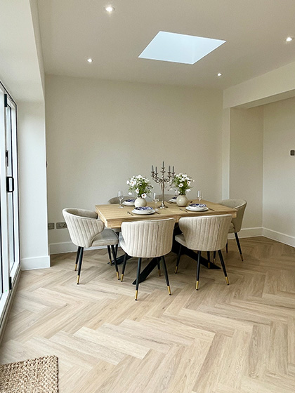 Open plan dining room with wood table and stylish chairs