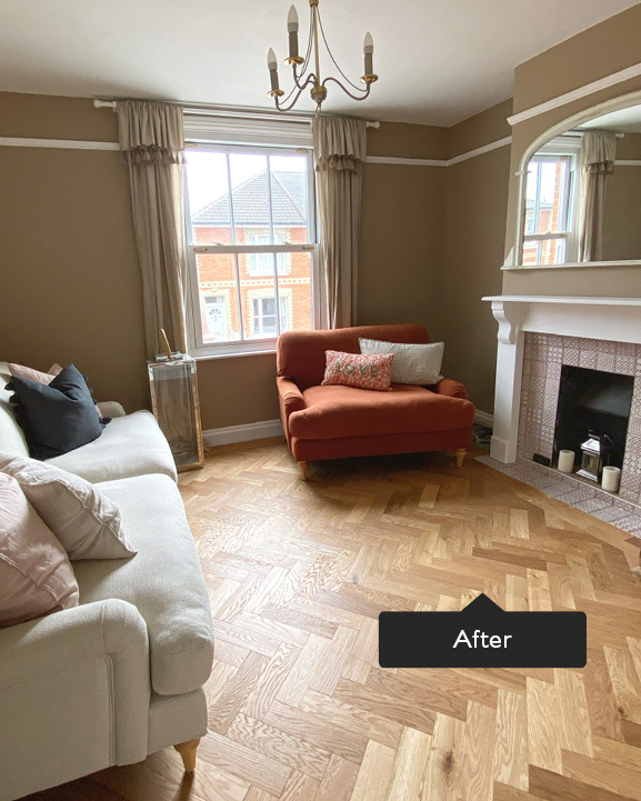 Living room with herringbone flooring and statement sofas