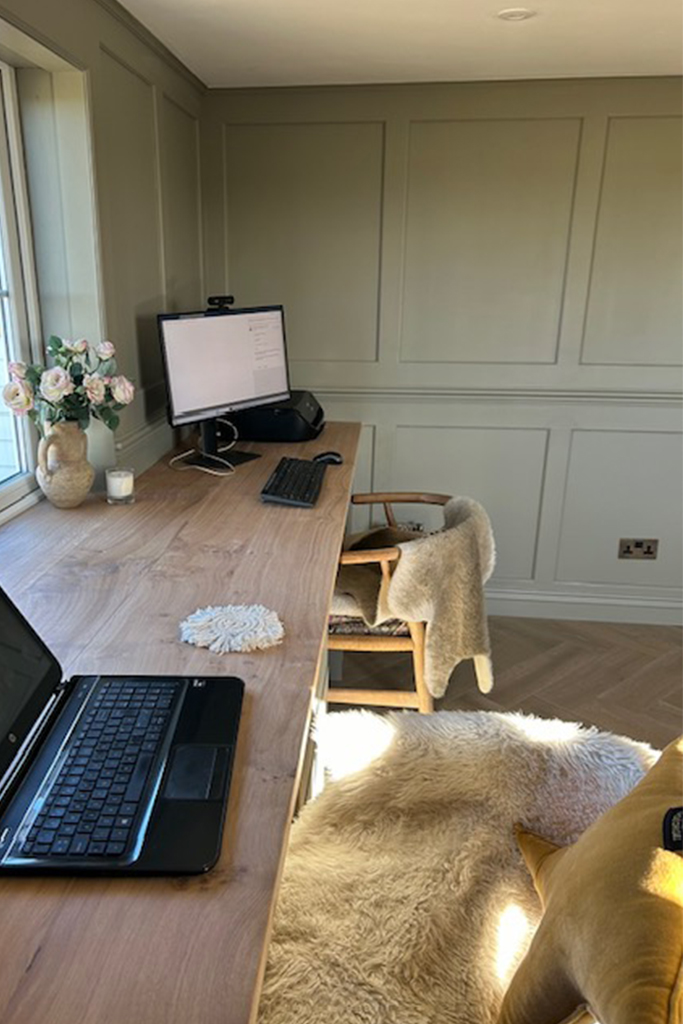 Office room with wooden desk and chairs with sheep skin throws