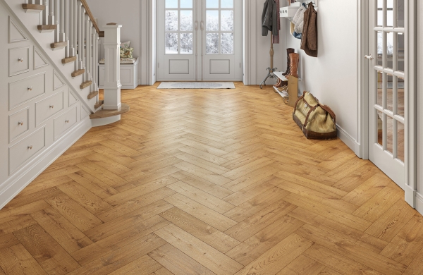 Big open hallway with white under stairs storage drawers and golden oak herringbone flooring